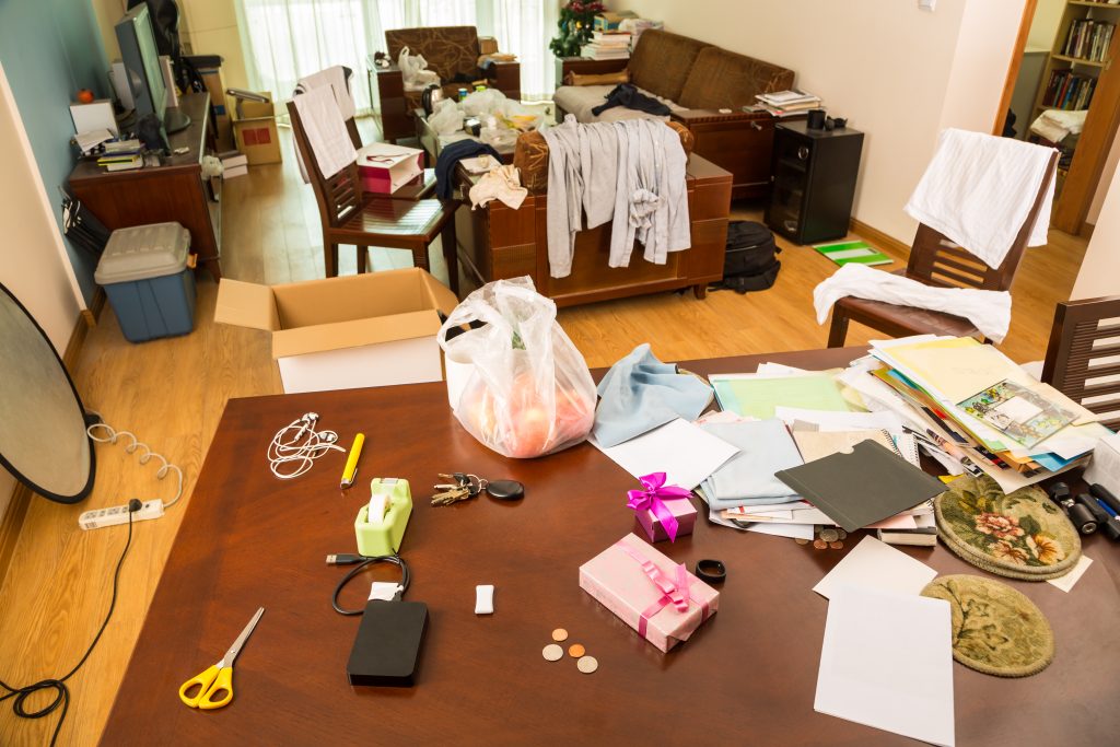 Messy living room with clothes and other stuff